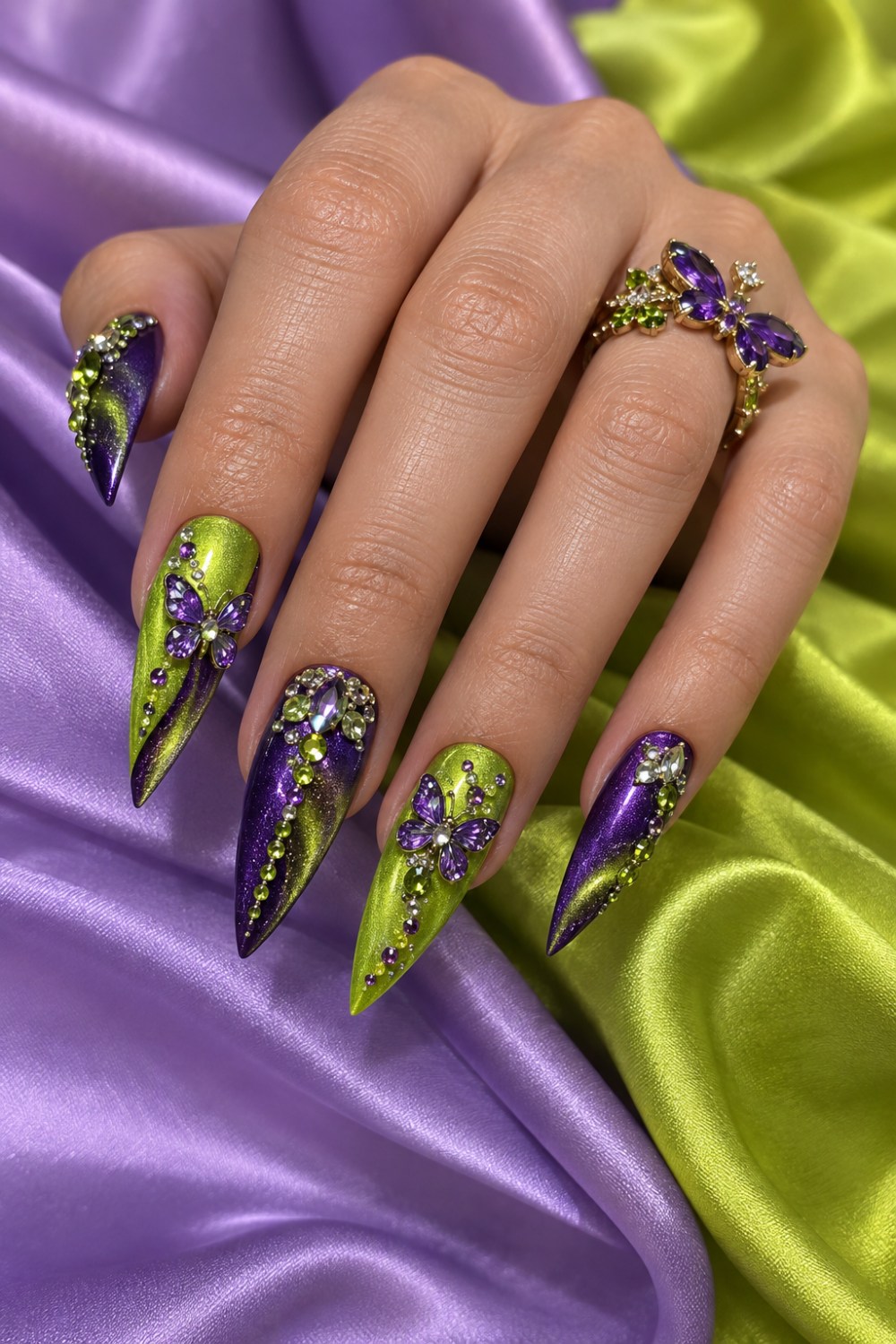 Neon-lime and violet cat-eye polish with crystal butterflies.