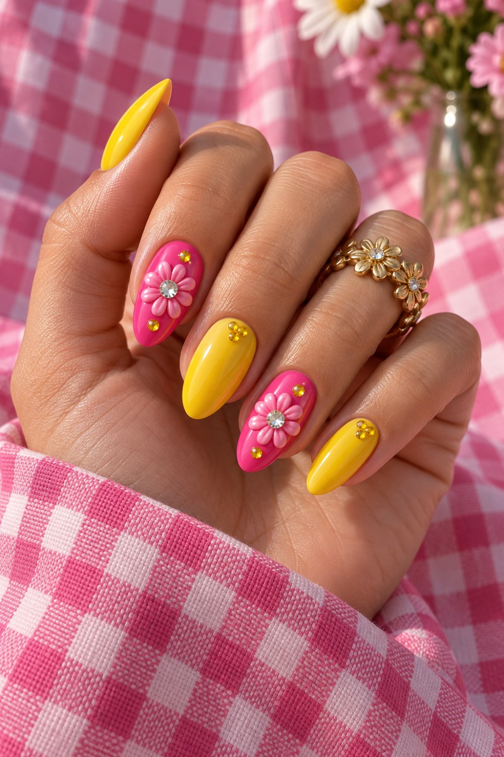 Hot-pink and sunshine-yellow nails with sculpted daisies.